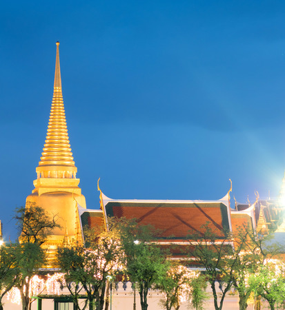 Outside beautiful landmark view of The Grand Emerald temple in Bangkok, Thailand with night light view and street light flareの写真素材