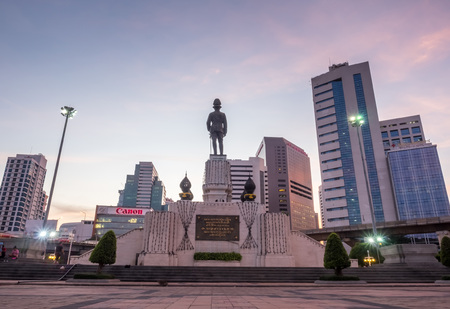 BANGKOK - DECEMBER 18: Back of King Rama VI statue with modern buildings in Bangkok, Thailand, was...
