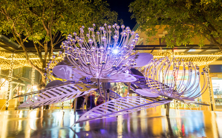 Modern art brittle fountain on pond under night skyの写真素材
