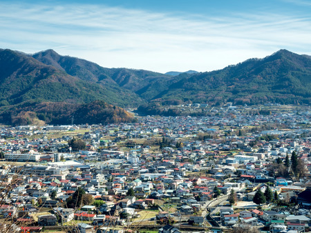Mountain with cityscape view under blue sky in Japanの写真素材