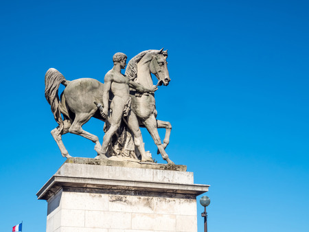 Beautiful horse and naked man sculpture near Eiffel tower in Paris, France, under blue skyの写真素材