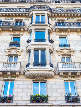Repetitive design of windows, doors and corridors of building in Parisの写真素材