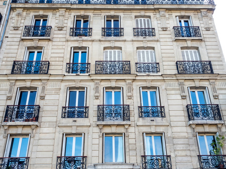 Repetitive design of windows, doors and corridors of building in Parisの写真素材