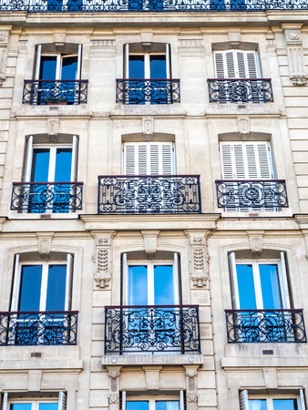 Repetitive design of windows, doors and corridors of building in Parisの写真素材