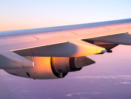 Jet engine of aircraft with outside morning warm sunlightの写真素材