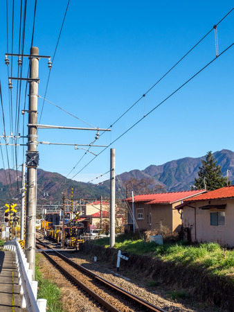 Rail track in rural area in Japan under blue skyの写真素材