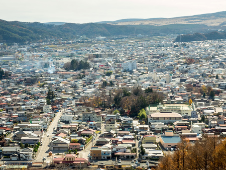 SHIMOYOSHIDA - NOVEMBER 24: Cityscape of Shimoyoshida town, near Kawaguchiko lake, in Japan, view from hill under cloudy sky, was taken on November 24, 2015.のeditorial素材