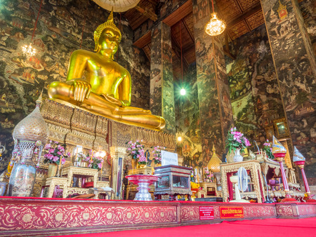 Main golden buddha statue in main church of Wat Suthat, delicate and unique Thai art, and Thai mural art, in Bangkok, Thailand / Thai word mean be quiet and please sit downのeditorial素材