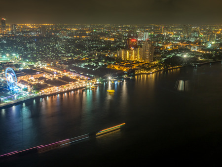 BANGKOK - MARCH 9: Skyscaper building view of Asiatique, large famous community mall along Chaophraya river, shown night light view with dark sky and river, in Bangkok, Thailand, was taken on March 9, 2016.のeditorial素材