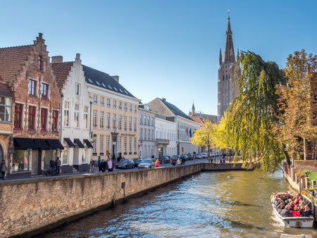 Brugge city scenes in Belgium, residential buildings, church, attractive and beautiful scenes, under blue skyのeditorial素材