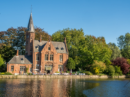 Brugge city scenes in Belgium, residential buildings, church, attractive and beautiful scenes, under blue skyのeditorial素材