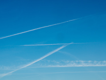 Cloudy sky with aircraft contrails for backgroundの写真素材