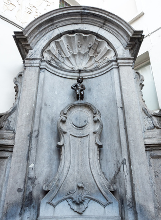 The small ,61 cm tall,  bronze statue on the corner of Rue de l'Etuve and Rue des Grands, known as "Manneken Pis" is symbol of Brussels in Belgiumのeditorial素材