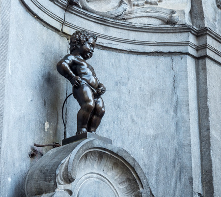 The small ,61 cm tall,  bronze statue on the corner of Rue de l'Etuve and Rue des Grands, known as "Manneken Pis" is symbol of Brussels in Belgiumのeditorial素材