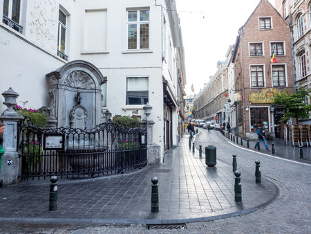 The small ,61 cm tall,  bronze statue on the corner of Rue de l'Etuve and Rue des Grands, known as "Manneken Pis" is symbol of Brussels in Belgiumのeditorial素材