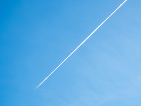 Cloudy sky with aircraft contrails for backgroundの写真素材