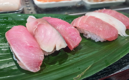 Sushi is luxury authentic Japanese food, made by various raw fish place on sour rice, selective focus on one pieceの写真素材