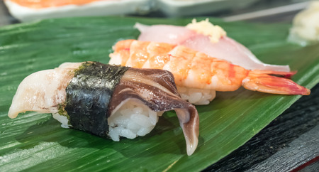 Sushi is luxury authentic Japanese food, made by various raw fish place on sour rice, selective focus on one pieceの写真素材