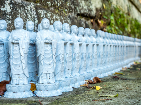 Lots of little monk buddha stone statue in Japan templeの写真素材