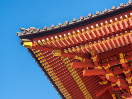 Japanese roof top art in temple under clear blue skyの写真素材