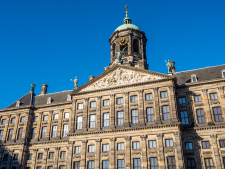 The front of Royal Palace at the Dam Square, Amsterdam, built as city hall during the Dutch Golden Age in the seventeenth century, under blue skyのeditorial素材