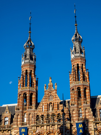 Top of building in Dam Square in Amsterdam, outstanding with European architecture art, under blue sky with moonの写真素材