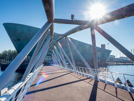 AMSTERDAM - OCTOBER 2: NEMO is landmark museum side of pier in Amsterdam, Netherlands, with flare effect technique, on October 2, 2015.のeditorial素材