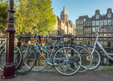 AMSTERDAM - OCTOBER 2: Saint Nichlas church front of  red light district under blue sky with bicycles and warm morning scene in Amsterdam, Netherlands, was taken on October 2, 2015.のeditorial素材