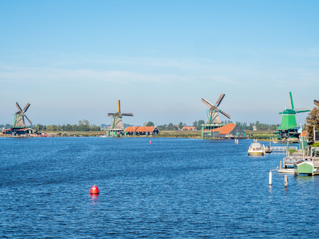 Zaan Schans is popular attractions in Netherlands, has a collection of well-preserved historic windmills and houses, this view from bridge under blue skyの写真素材