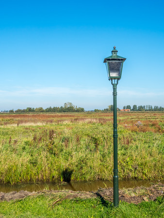 City scene of Zaan Schans, small town of historic windmills, shown rural scenes under clear blue skyの写真素材