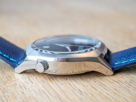 BOURNMOUTH - MAY 18: Blue dial and blue leather strap Bulova watch on wooden table with natural morning lightのeditorial素材