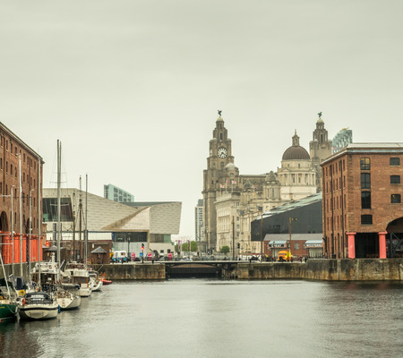 LIVERPOOL - MAY 20 : The Albert Dock, the UNESCO World Heritage place, is important historic place in Liverpool city, England, under cloudy white sky, was taken on May 20, 2016.のeditorial素材