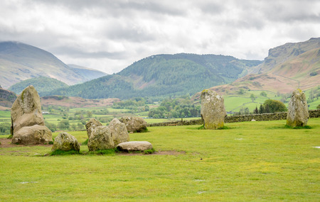 Castlerigg stone circle in Keswick, Cumbria, England, was constructed from prehistoric era, during the Late Neolithic and Early Bronze Ages, under cloudy sky.の写真素材