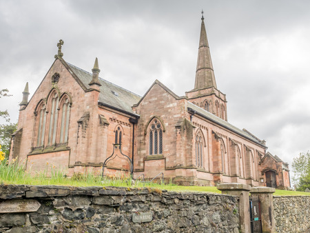 Parish Church of Keswick Saint John, England, on hill under cloudy skyの写真素材