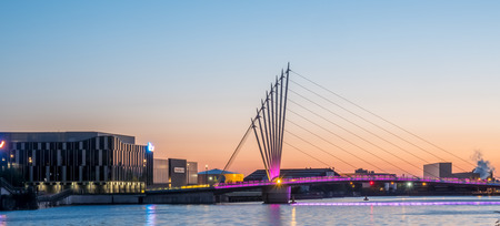 MANCHESTER - MAY 22: Foot bridge cross Manchester ship canal, connecting between BBC Media City, ITV studio buildings and Imperial War Museum at Salford quays in Manchester city, England, under twilight sky, on May 22, 2016.のeditorial素材