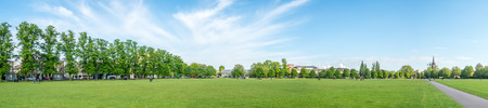 CAMBRIDGE - MAY 23 : Panoramic view of green grass relax outdoor park with cloudy blue sky in...