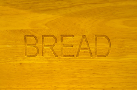 Bread word engrave in wooden boardの写真素材