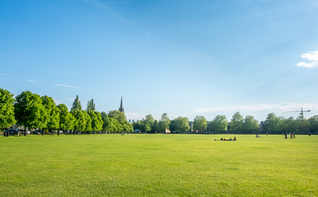 CAMBRIDGE - MAY 23 : Green grass relax outdoor park with cloudy blue sky in Cambridge, England, was taken on May 23, 2016.のeditorial素材
