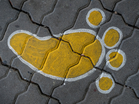 Footprint cartoon paint on brick floorの写真素材