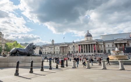 LONDON - MAY 24: Trafalgar square, panoramic view including Lion statue and The National Gallery building, under cloudy sky in London, England, was taken on May 24, 2016.のeditorial素材