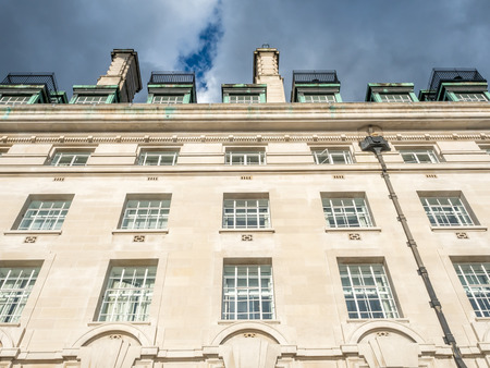 County Hall buildings, located along river Thames in London, England, under rainy cloudy skyのeditorial素材