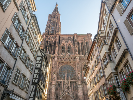 Huge tower and elegant exterior architecture of Notre dam of Strasbourg cathedral in Strasbourg, France, with morning sunlightの写真素材