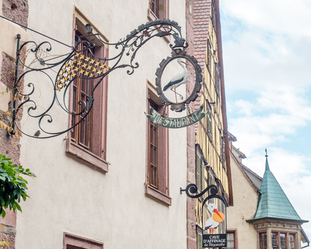 RIQUEWIHR - OCTOBER 9: City scene with walking street in Riquewihr, France, under cloudy sky, on October 9, 2016.のeditorial素材