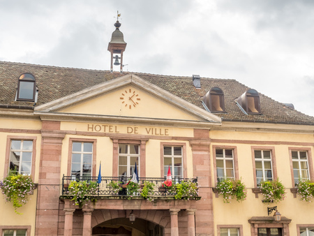 RIQUEWIHR - OCTOBER 9: City scene with walking street in Riquewihr, France, under cloudy sky, on October 9, 2016.のeditorial素材