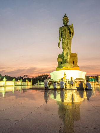 NAKORNPATHOM - DECEMBER 12 : Grand Walking Buddha statue, the main statue of Buddhist diocese, under twilight golden sky with warm tone color, in Nakornpathom, Thailand, on December 12, 2016.のeditorial素材