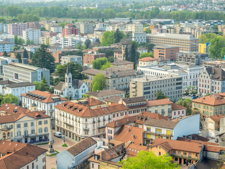 Bellinzona cityscape view from castle under cloudy blue sky in Switzerland, surrounding with high Alps mountainsのeditorial素材