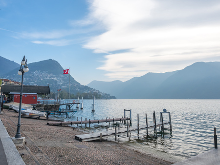 LUGANO - APRIL 7 : Natural scenic view around Lake Lugano under cloudy blue sky in Lugano, Switzerland , on April 7, 2017.のeditorial素材