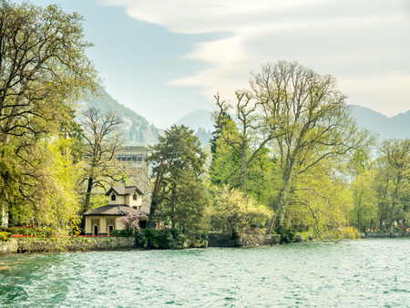 LUGANO - APRIL 7 : Natural scenic view around Lake Lugano under cloudy blue sky in Lugano, Switzerland , on April 7, 2017.のeditorial素材