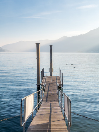 Landscape view of Lake Maggiore in Locarno with flare effect in Switzerlandの写真素材