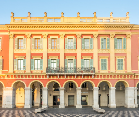 NICE - APRIL 9 : Red ochre Italian style buildings at Massena square, main center of city, in Nice, France, on April 9, 2017.のeditorial素材